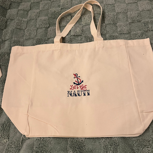 Reusable shopping bag with Let's get Nauti embroidered on it
